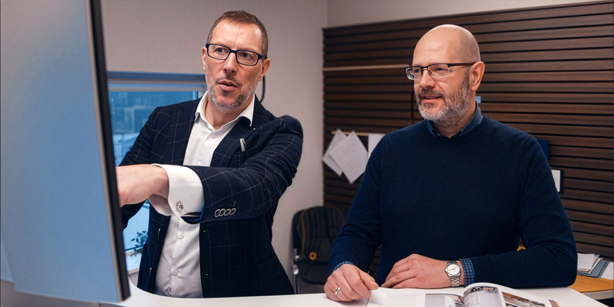 Two Shomera architects reviewing a design on screen in the studio