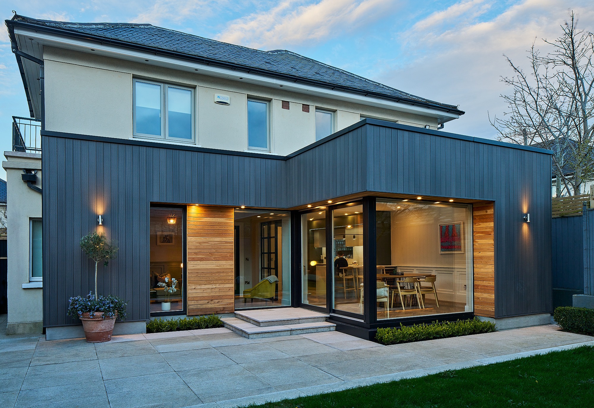 A premium Shomera house extension lit at dusk